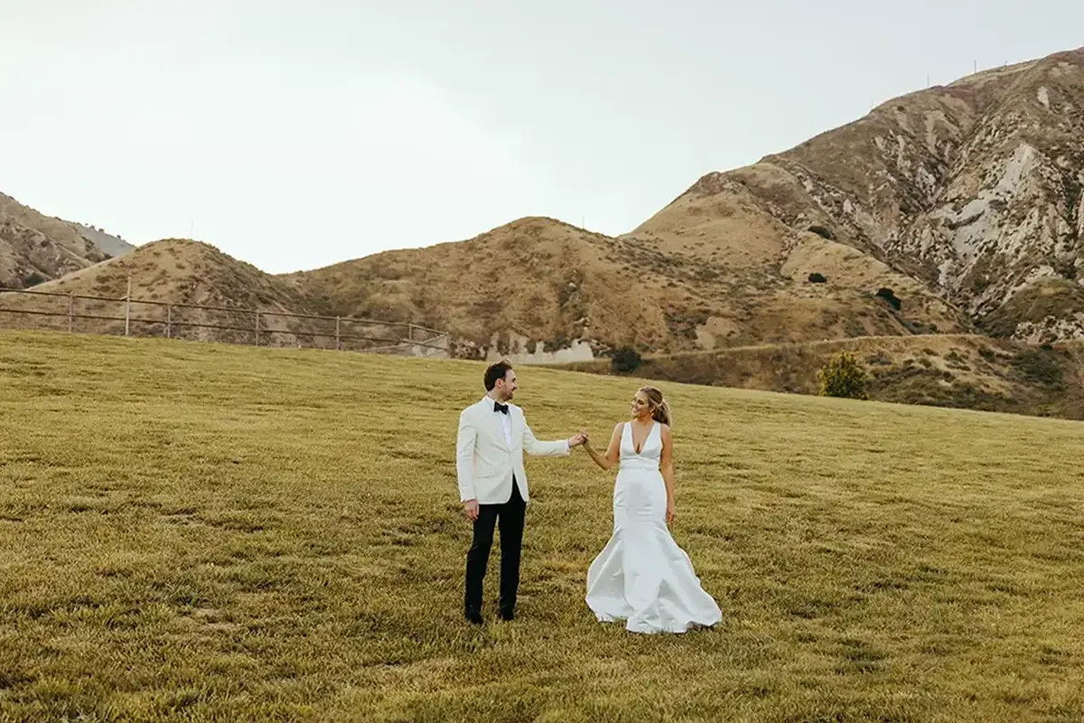 bride and groom holding hands