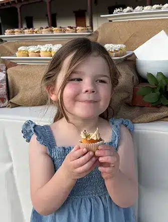 Little girl eating cupcake