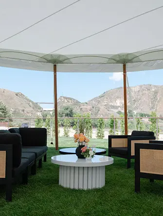 Tables and chairs under a white tent